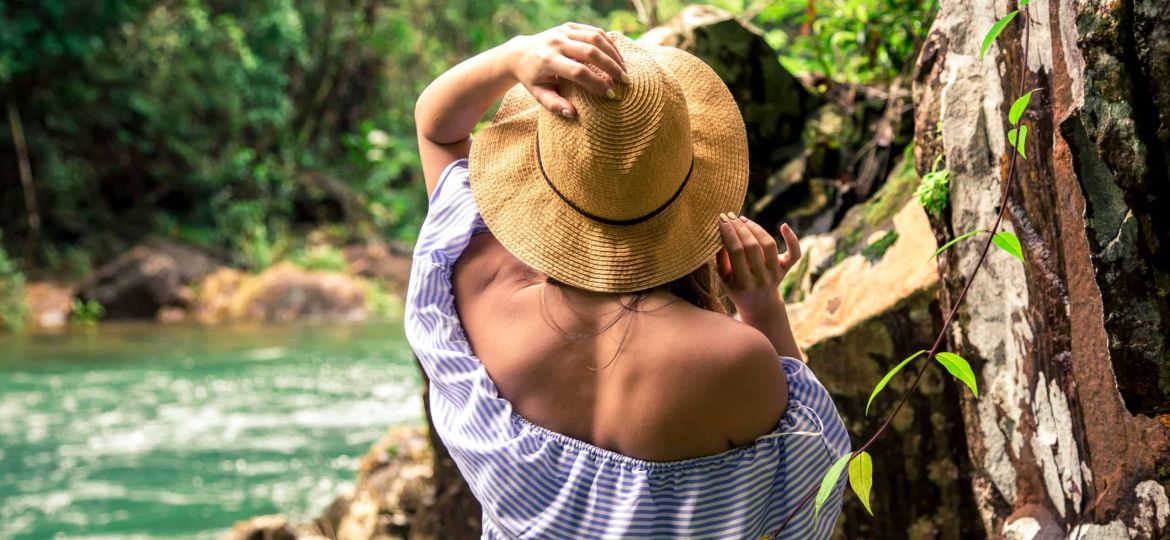 girl in hat at the river